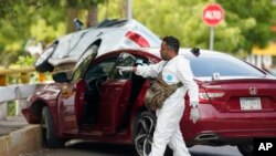 A forensic medical examiner works at the scene where an unidentified man was killed, in Apatzingan, Mexico, July 2, 2023.