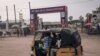 A "tuk-tuk" cab passes the entrance to one of the facilities of the 9th Jeux de la Francophonie in Kinshasa, Democratic Republic of Congo, on July 25, 2023. 