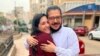 FILE - In this photo provided by Egyptian Initiative for Personal Rights, human rights researcher Patrick Zaki hugs his sister after his release from pretrial detention in Mansoura, Egypt, on Dec. 8, 2021. Egyptian President Abdel Fattah al-Sisi pardoned Zaki on July 19, 2023. 