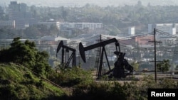 FILE - Active pumpjacks from oil wells are pictured at the Inglewood Oil Field, the largest urban oil field in the United States, from the Baldwin Hills Scenic Overlook in Culver City, California, March 10, 2022. 