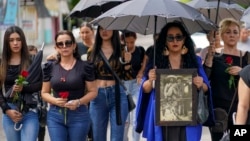 Mourners arrive to the funeral of armed civilian defense leader Hipolito Mora and two of his bodyguards at his home in La Ruana, Mexico, July 1, 2023.
