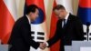 South Korea's President Yoon Suk Yeol shakes hands with Polish President Andrzej Duda, as they attend a joint press conference at the Presidential Palace in Warsaw, Poland, July 13, 2023.