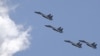 FILE - J-11B fighter jets of the Chinese Air Force fly during a training session on the outskirts of Beijing, July 2, 2015. China's air force and navy staged another large-scale drill involving fighters, bombers and warships to Taiwan's south and southwest on Tuesday.
