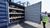 Marc Trent, CEO of vehicle dismantler company Charles Trent Ltd, opens up a specially-built, fire-safe container for batteries salvaged from written-off electric vehicles and hybrids in Poole, Britain, June 7, 2023.