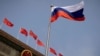 FILE - The Russian flag flies in front of the Great Hall of the People before a welcoming ceremony for Russian Prime Minister Mikhail Mishustin in Beijing, China, May 24, 2023. 
