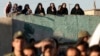 FILE - Iranians watch the hanging of convicted a man, unseen, in Qazvin, about 130 kilometers northwest of the capital Tehran, Iran, May, 26, 2011. A similar execution took place Aug. 26, 2024, in Shahroud, in northern Iran. (Mehr News Agency via AP)