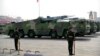 FILE - Chinese military vehicles carrying DF-17 ballistic missiles roll during a parade to commemorate the 70th anniversary of the founding of Communist China in Beijing, on Oct. 1, 2019.