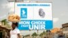 Une femme passe devant une affiche de campagne du parti au pouvoir Union pour la République (UNIR), à Lomé, le 24 avril 2024. 