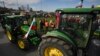 FILE - Farmers drive tractors during an action to block trucks crossing the Danube bridge, marking the border between Bulgaria and Romania, in a protest against the duty-free import of grain coming from Ukraine into the EU, in Rousse, Bulgaria, on March 29, 2023.