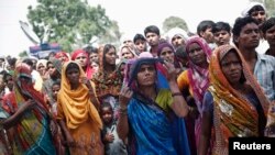 উত্তর ভারতের উত্তর প্রদেশ রাজ্যের বুদাউন জেলায় যে গাছে দুই ধর্ষিত কিশোরীর লাখ ঝুলন্ত অবস্থায় পাওয়া গিয়েছিল সেখানে দর্শকরা দাঁড়িয়ে আছে। ৩১ মে, ২০১৪। ফাইল ছবি। 