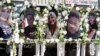 FILE - Photographs of victims of a mass shooting at a nearby gay nightclub are on display at a memorial in Colorado Springs, Colorado, Nov. 22, 2022. 