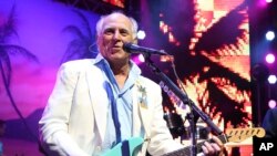 FILE - Jimmy Buffett performs at the after party for the premiere of 'Jurassic World' in Los Angeles, on June 9, 2015. 