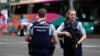Police officers stand outside a hotel housing a team from the FIFA Women's World Cup in the central business district following a shooting in Auckland, New Zealand, July 20, 2023. 