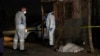 Police stand near a covered body in the Angelo settlement in Boksburg, South Africa, July 6, 2023. 