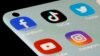 FILE - Facebook, TikTok, Twitter, YouTube and Instagram apps are seen on a smartphone in this illustration taken, July 13, 2021.