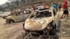 This handout picture released on the Facebook page of Radio Soummam Bejaia on July 24, 2023, shows vehicles burnt in Algeria's wildfires, in the town of Toudja, as temperatures hit 48 degrees Celsius.