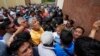 Neighbors and voters gather at a polling station after electoral authorities delayed its opening due to alleged electoral violations during general elections in San Jose El Golfo on the outskirts of Guatemala City, June 25, 2023.