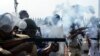Police fire tear gas to disperse people protesting the rape and murder of a resident doctor at a government hospital earlier this month, in Kolkata, India, Aug. 27, 2024.