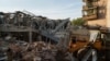 A tractor clears the rubble after a Russian strike on the Sapphire hotel in Kramatorsk, Donetsk region, Ukraine, Aug. 25, 2024. 