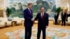 U.S. Special Presidential Envoy for Climate John Kerry, left, and Chinese Premier Li Qiang shake hands before a meeting at the Great Hall of the People in Beijing, July 18, 2023. 