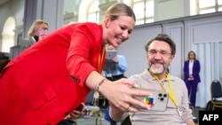 FILE - Journalists, including Ksenia Sobchak (left) and Sergei Shnurov, the lead singer of hit rock group Leningrad, at the Manezh exhibition hall in Moscow, December 23, 2021.