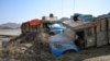 Damaged trucks are seen buried in the mud after the collapse of the Arbaat Dam, 40km north of Port Sudan following heavy rains and torrential floods, Aug. 25, 2024. 