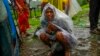 A woman whose family members are trapped under rubble wails after a landslide washed away houses in Raigad district, western Maharashtra state, India, July 20, 2023. 