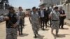 Italian Interior Minister Matteo Salvini, center,visits the Tripoli naval base, in Tripoli, Libya, June 25, 2018.