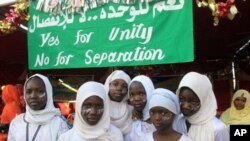 Young Sudanese supporters wait for the arrival of Nafie Ali Nafie, deputy head of Sudan's ruling National Congress Party and assistant of president Omar al-Bashir, to address a crowd on upcoming referendum, 9 Nov 2010