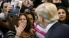 FILE - A woman blows a kiss to Republican presidential candidate Donald Trump (R) after Trump autographed her chest at his campaign rally in Manassas, Virginia, Dec. 2, 2015. 
