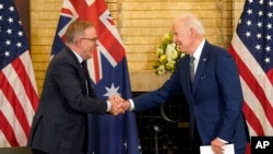Presiden Joe Biden, kanan, berjabat tangan dengan Perdana Menteri Australia Anthony Albanese selama pertemuan puncak para pemimpin Quad di Istana Kantei, 24 Mei 2022, di Tokyo. (Foto: AP)