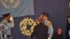 Secretary-General Ban Ki-moon faces flag that flew over UN mission in Haiti at memorial service in New York, 19 Jan 2010