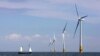 FILE - A boat sails towards a wind farm off the coast of Whitstable, on the coast of southeastern England, July 11, 2006. Britain has invested heavily in renewable energy before reaching Tuesday's first coal-free day milestone.