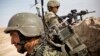 A member of the Afghan National Army provides security with a soldier from the U.S. Army's Bravo Company, 1st Battalion, 36th Infantry Regiment during a patrol near Command Outpost AJK (short for Azim-Jan-Kariz, a near-by village) in Maiwand District, Kan