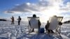 FILE - People enjoy the sunny weather on ice on the waterfront of Helsinki, Finland Feb. 14, 2021.