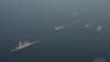 Military vessels escort tugboats as they sail toward the damaged oil tanker Sounion, which has been on fire since Aug. 23, after an attack by Houthi militants, on the Red Sea, Sept. 14, 2024. (Eunavfor Aspides via Reuters)