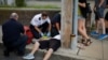 FILE - Cataldo Ambulance medics and other first responders revive a 32-year-old man who was found unresponsive and not breathing after an opioid overdose on a sidewalk in the Boston suburb of Everett, Massachusetts, Aug. 23, 2017. 