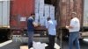FILE - Customs officials inspect a convoy of humanitarian aid after it crossed into Syria from Turkey through the Bab al-Hawa border crossing, July 8, 2022.