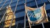 A Pfizer flag is displayed in front of world headquarters in New York, Nov. 23, 2015.