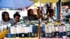 Women vendors display Nokia phone models for sale along with smartphones in Ikeja district in Nigeria's commercial capital Lagos, May 31, 2017.