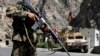 FILE - In this Aug. 27, 2013 photo, Afghan National Army soldiers stand guard on the outskirts of in Kabul, Afghanistan.