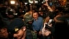 Former Thai Education Minister Chaturon Chaisang (C), who had been on the run after refusing to turn himself in to the military after being summoned, is surrounded by soldiers and reporters as he is being detained after giving a talk at the Foreign Corres