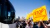FILE - Demonstrators rally against the arrival of undocumented migrants who were scheduled to be processed at the Murrieta Border Patrol Station in Murrieta, California, July 1, 2014.