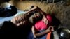 A Rohingya refugee man lies at his shelter in Kutupalong refugees camp in Cox's Bazar, Bangladesh, Oct. 20, 2017.