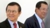 FILE PHOTO - Cambodia's Prime Minister Hun Sen, right, walks with opposition Cambodia Rescue Party Deputy President Kem Sokha, left, during a break at National Assembly in Phnom Penh, Cambodia, Wednesday, Dec. 7, 2016. 
