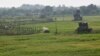 Indian security posts, right, are seen along the border between India and Pakistan in Suchetgarh near Jammu, Oct. 9, 2014. 