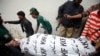 Men move the body of Syed Manzar Imam, a member of the Muttahida Qaumi Movement (MQM) political party and the Sindh provincial assembly who was killed by unidentified gunmen, from the morgue in Karachi's Abbasi Shaheed hospital, January 17, 2013. 