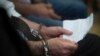 Syrian immigrant Ahmed Hamed holds a paper in his hands in the courtroom during his appeal trial in the appeals court in Szeged, 170 kms southeast of Budapest, Hungary, June 15, 2017. 