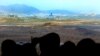 Visitors look at the industrial complex in Kaesong, North Korea, through binoculars at Dora Observation Post in the demilitarized zone (DMZ) near the border village of Panmunjom, in Paju, South Korea, April 9, 2013. 