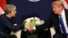 FILE - U.S. President Donald Trump shakes hands with British Prime Minister Theresa May during the World Economic Forum annual meeting in Davos, Switzerland, Jan. 25, 2018.